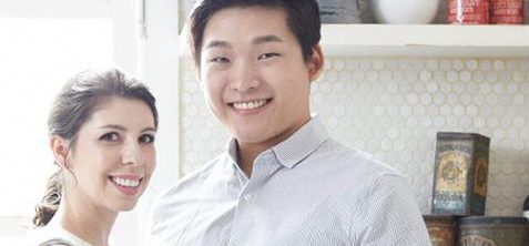 Two well-dressed students in a fancy kitchen