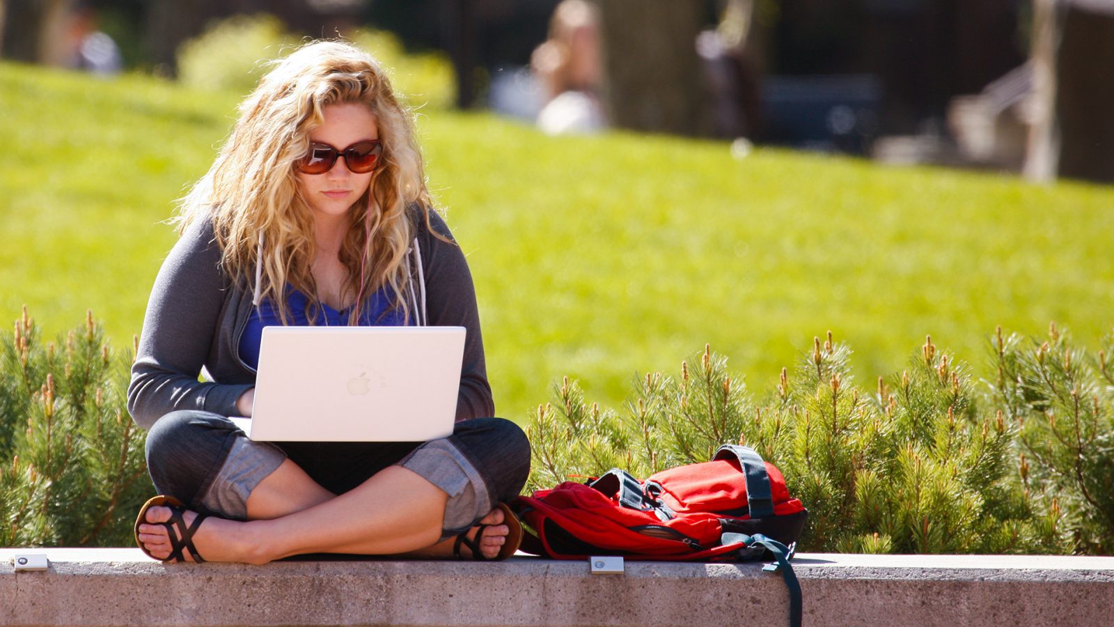 Photo: Student working outside on her laptop