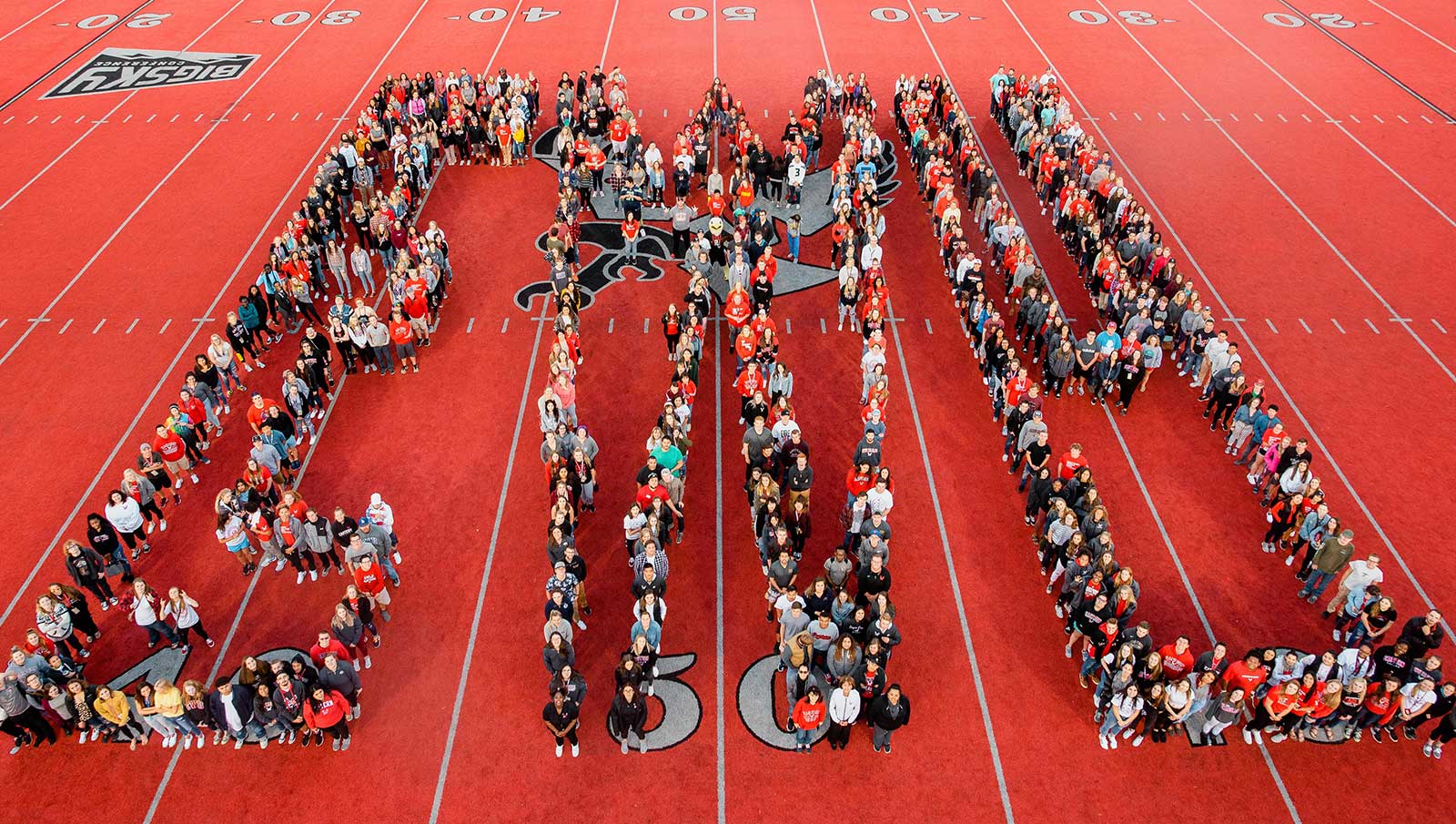 Photo: Students from the class of 2022 assemble to form the letters "EWU" on the red turf of Roos Field