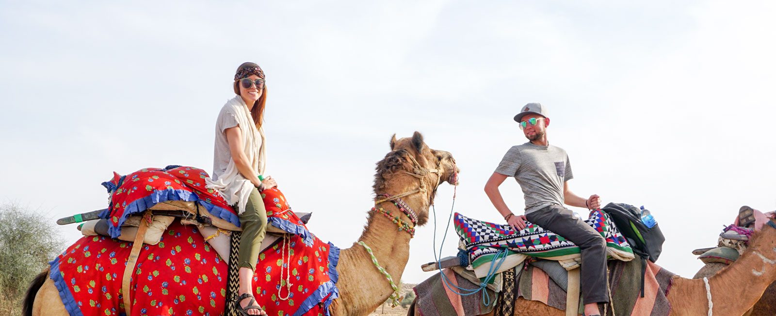 Photo: EWU alumni couple riding camels in the desert of India