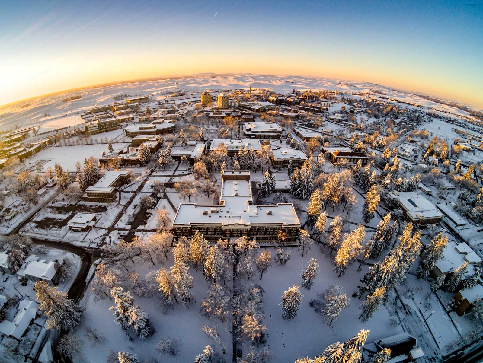 Photo: Aerial view of the EWU Cheney campus covered in fresh snow under a blue sky